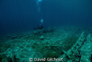 Diver/photographer explores wreckage in Little Tub Harbou... by David Gilchrist 
